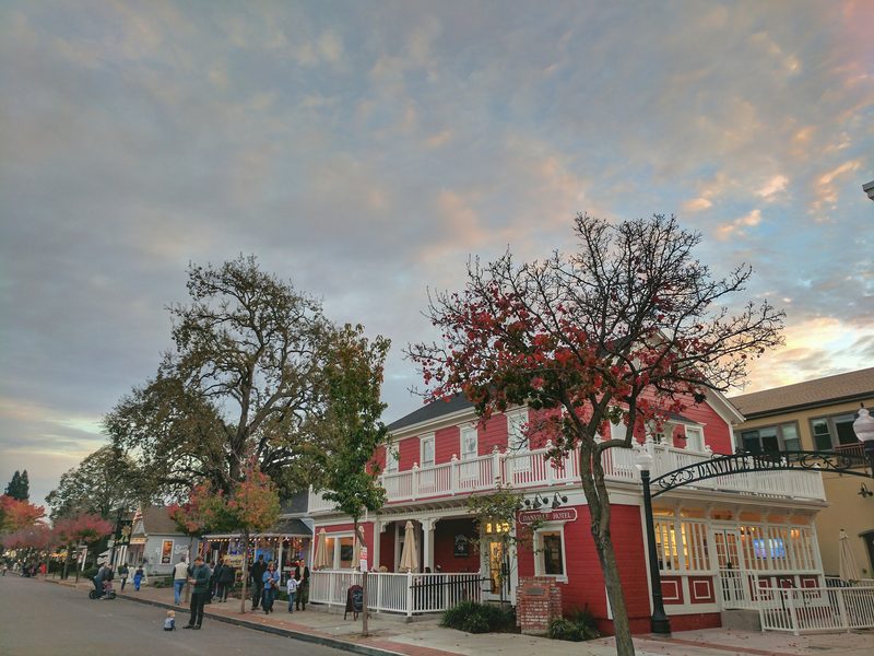 Downtown Danville's Hartz Avenue at dusk, with a red autumn tree and warm evening sky.